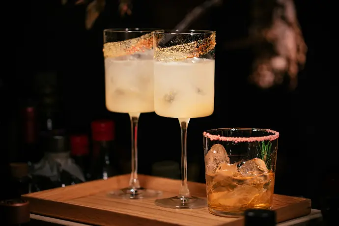 liquor filled wine glasses and rock glass